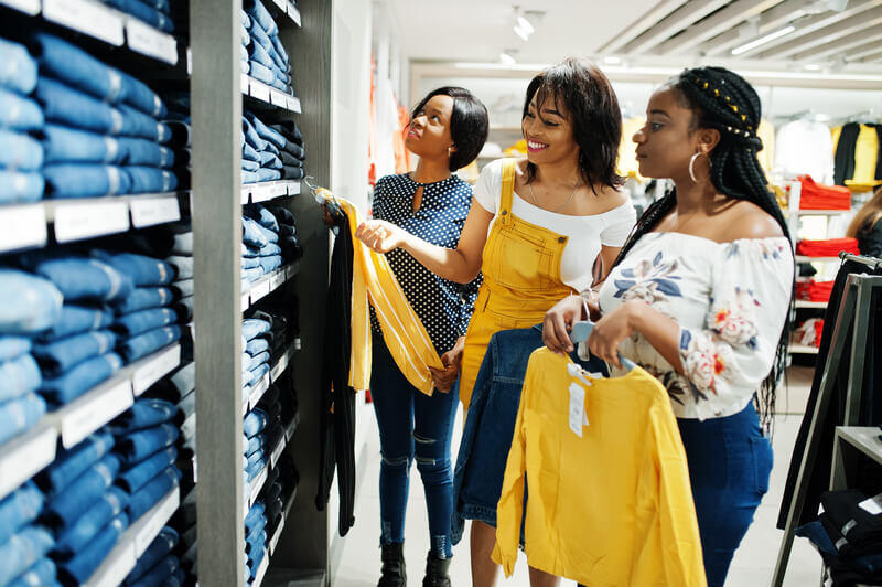 three-african-woman-choosing-clothes-store-shopping-day-they-buying-jeans